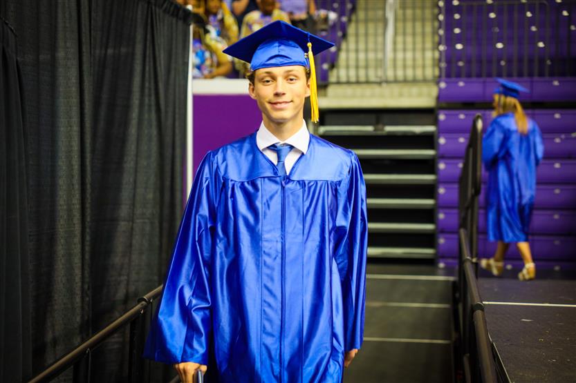 A group of graduates wearing blue robes